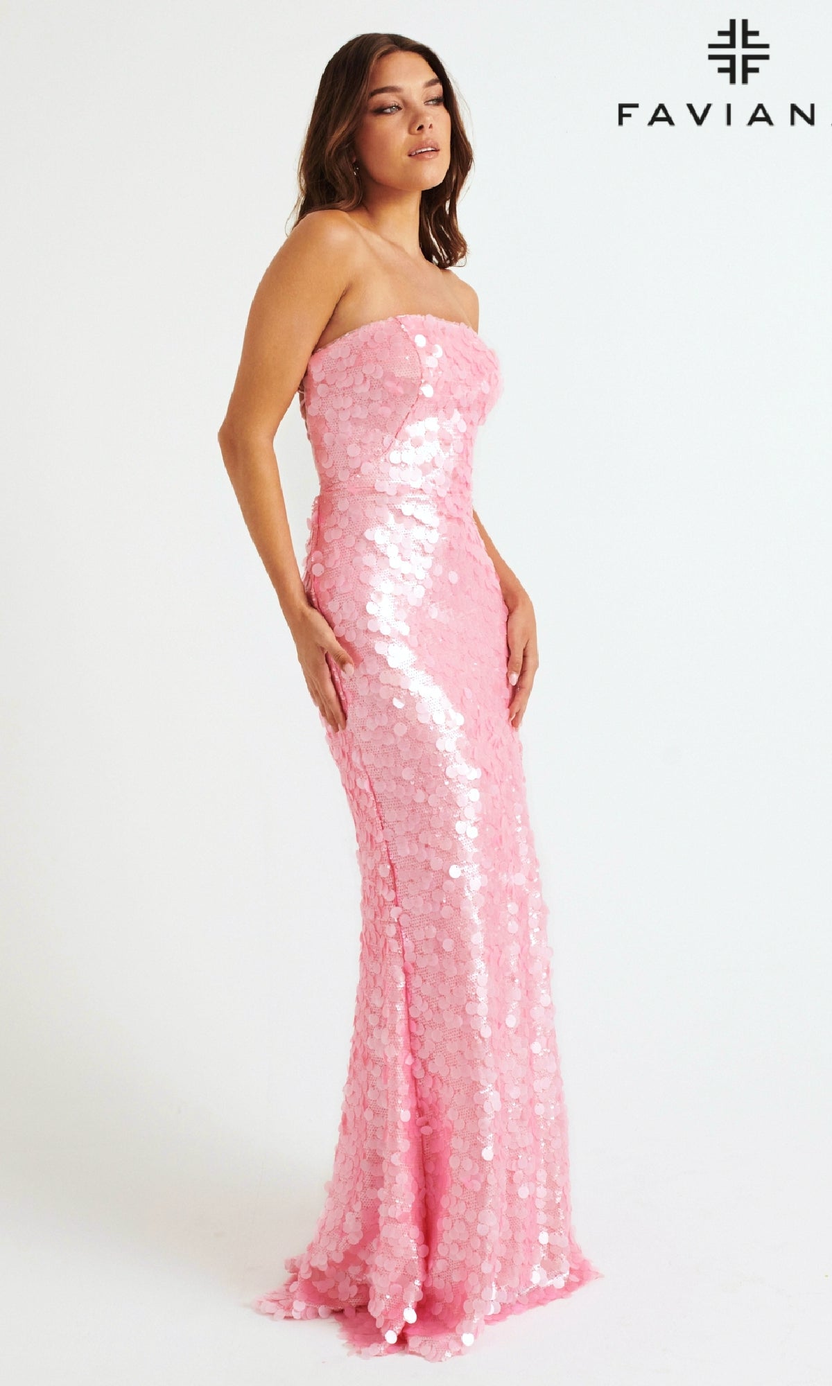 A woman models the Faviana 11258—a long, elegant strapless pink sequin prom dress—against a plain white background with the Faviana logo in the corner.